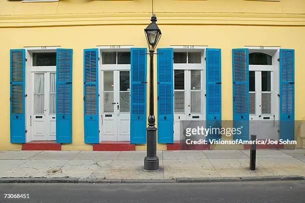 "blue shutter and lamp post in french quarter near bourbon street in new orleans, louisiana" - new orleans houses stock pictures, royalty-free photos & images