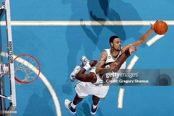 Tyson Chandler of the New Orleans/Oklahoma City Hornets moves for the ball as he collides with teammate Marc Jackson during the game against the...