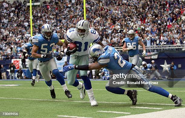 Wide receiver Terrell Owens of the Dallas Cowboys is tackled by Kenoy Kennedy of the Detroit Lions at Texas Stadium on December 31, 2006 in Dallas,...