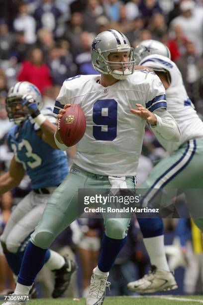 Quarterback Tony Romo of the Dallas Cowboys drops back to pass the ball during the game against the Detroit Lions at Texas Stadium on December 31,...