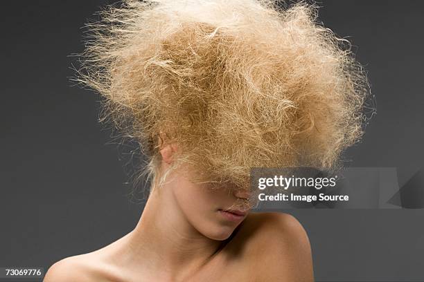 woman with frizzy hairstyle - dry hair stock pictures, royalty-free photos & images