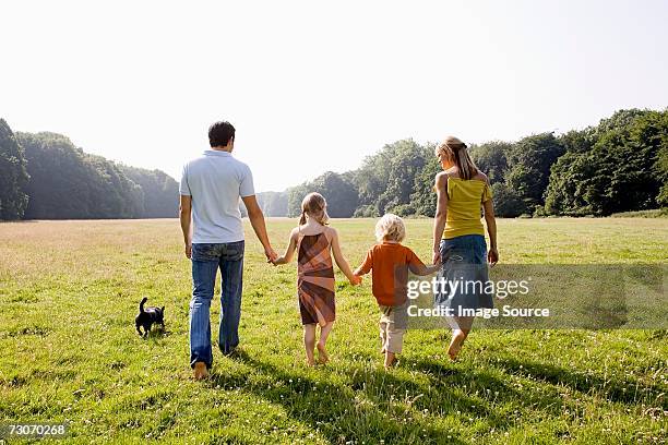 family holding hands - family children dog stock pictures, royalty-free photos & images