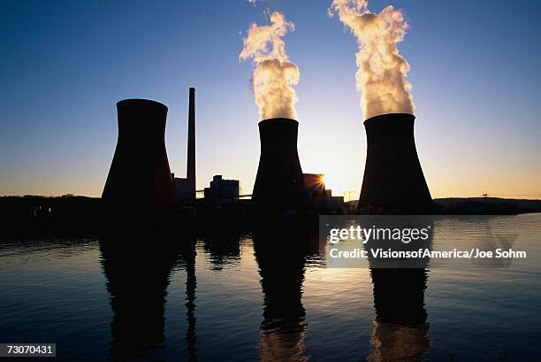 this is the john ames power plant. it is a coal utility company located on the kanoa river at sunset . - coal plant stock pictures, royalty-free photos & images