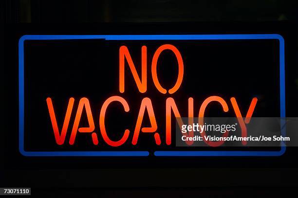 neon sign reads ?no vacancy? for a motel at night - no vacancies stock pictures, royalty-free photos & images