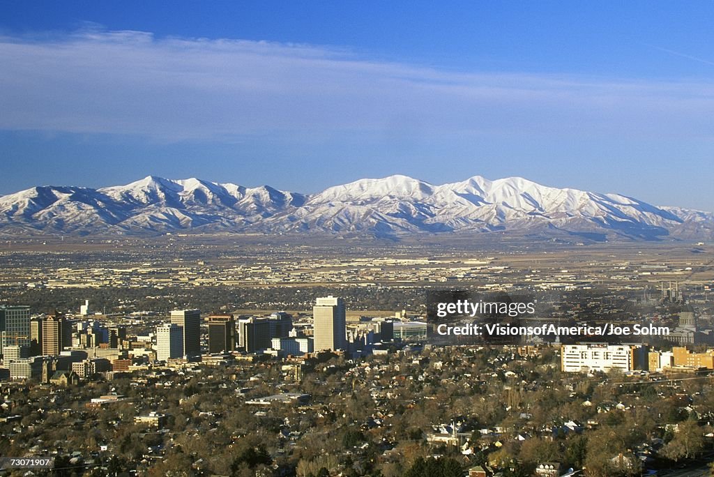 "Skyline of Salt Lake City, UT with Snow capped Wasatch Mountains in background"