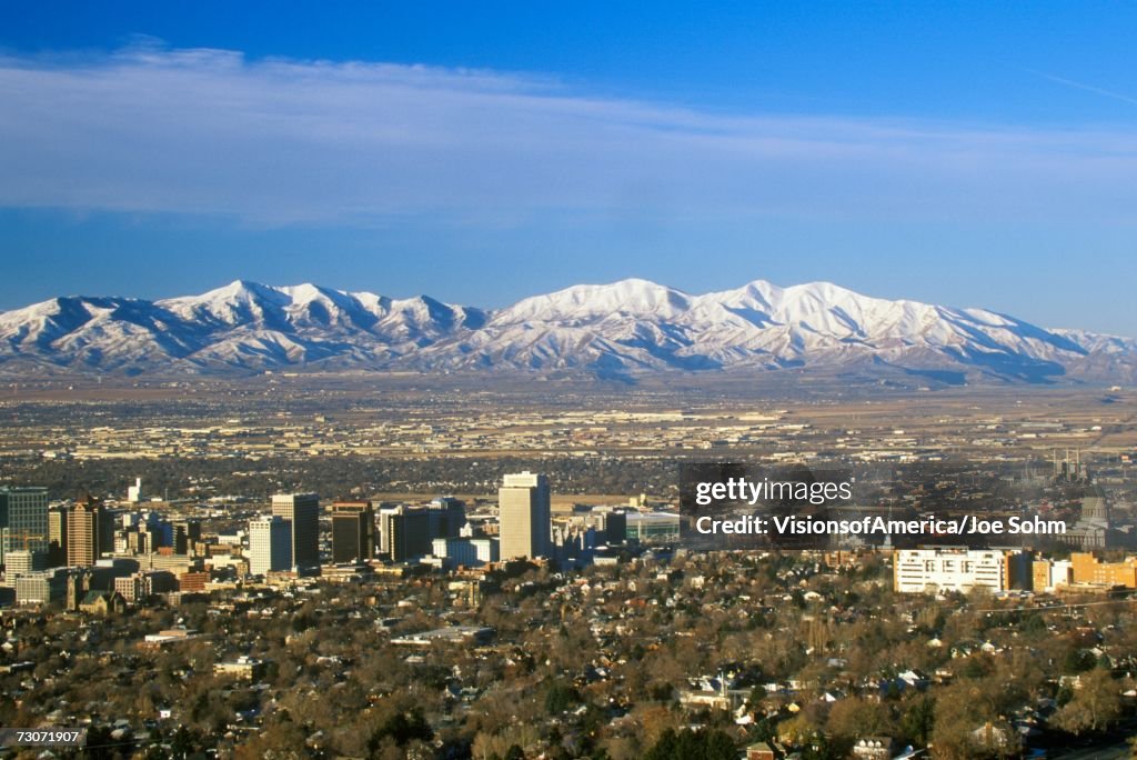 "Skyline of Salt Lake City, UT with Snow capped Wasatch Mountains in background"