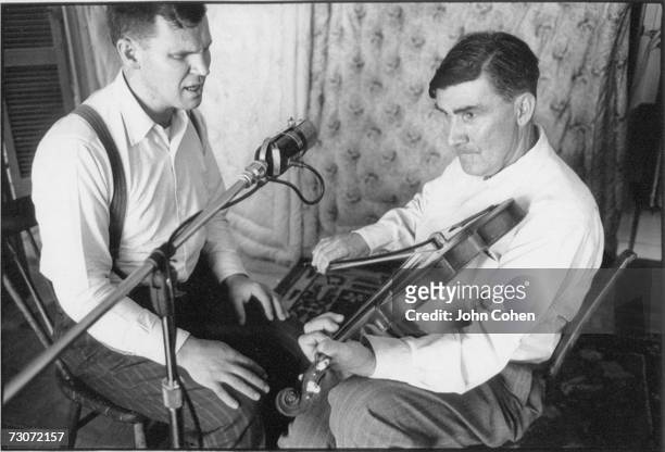 American bluegrass musician and singer Doc Watson, born Arthel Lane Watson, sings as father-in-law, fiddler Gaither Carlton , accompanies him on...