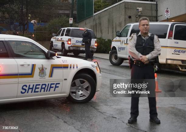 Sheriffs guard the entrance to the British Columbia Supreme Courthouse as accused serial killer Robert Pickton arrives for the first day of his...