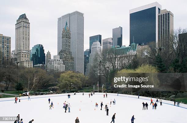 people ice skating in central park - central park winter stock pictures, royalty-free photos & images