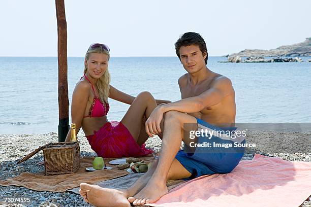 couple having romantic beach picnic - fat guy on beach bildbanksfoton och bilder