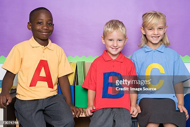 three primary school students - alphabetical order stock pictures, royalty-free photos & images