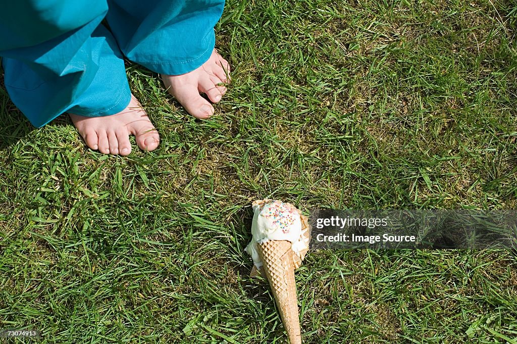 Feet of child and dropped ice cream