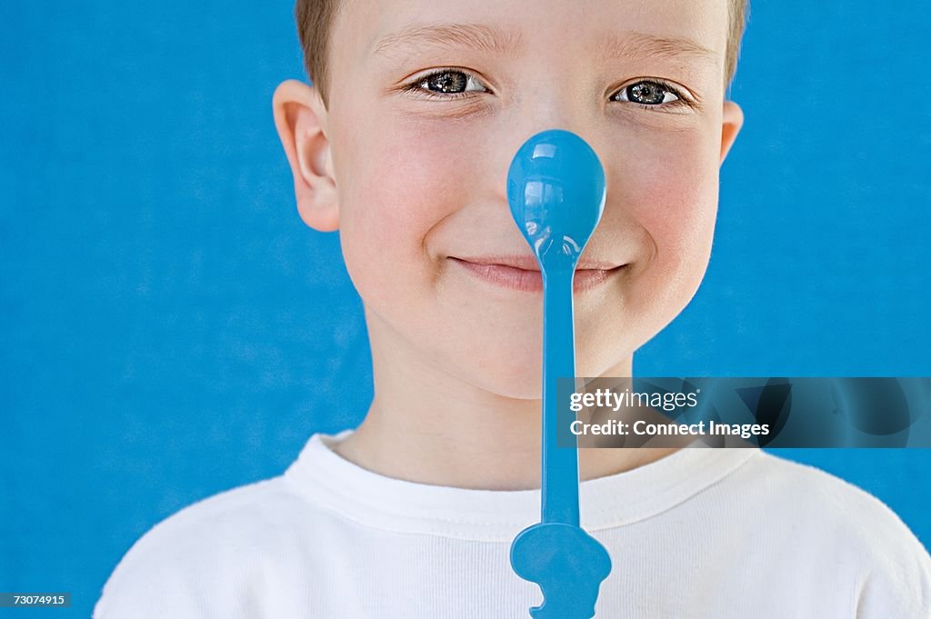 Boy with spoon on his nose