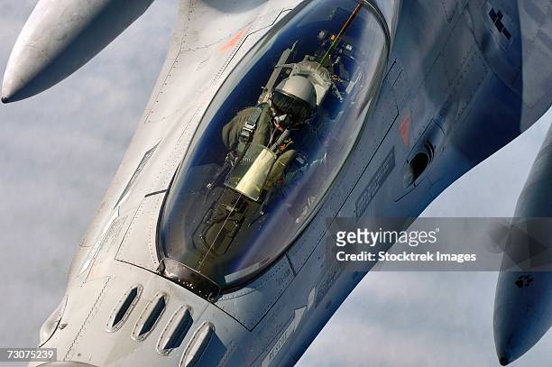 a belgian f-16 fighting falcon flies into contact position below and behind a kc-135 stratotanker from royal air force mildenhall, england, over the north sea on july 25. - f 16 fighting falcon stock pictures, royalty-free photos & images