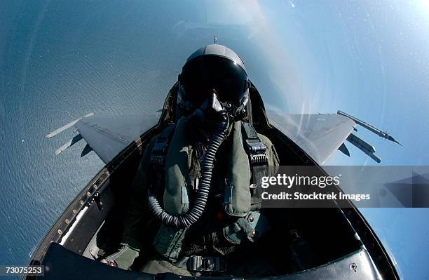 an f-16 fighting falcon searches for boats off the coast of south korea during an aim-9 missile live-fire exercise august 18. - fighter pilot in cockpit stock pictures, royalty-free photos & images