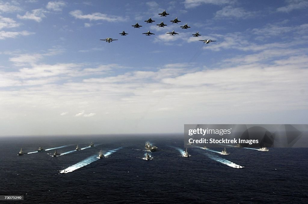 Pacific Ocean (November 14, 2006) - Aircraft assigned to Carrier Air Wing Five (CVW-5) fly over a group of 18 U.S. and Japanese Maritime Self-Defense Force ships, at the conclusion the two nations' exercise ANNUALEX.