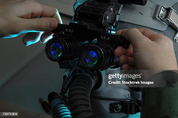 airman adjusts the eyespan on a pair of night vision goggles - night vision stock pictures, royalty-free photos & images