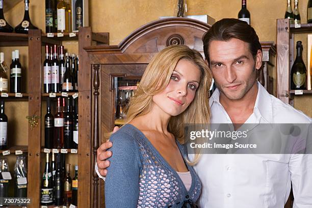 couple in a wine shop - mid adult couple stockfoto's en -beelden