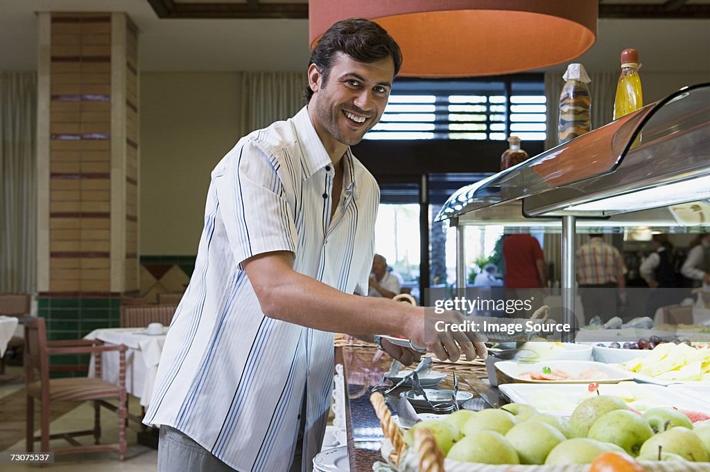 Man standing at buffet counter