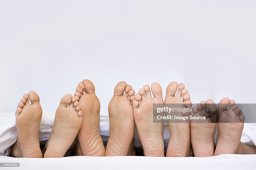 A row of bare feet