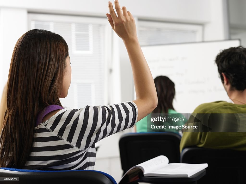 Student with arm raised