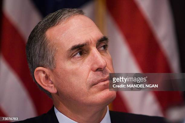 Washington, UNITED STATES: Lewis Hay, Chairman and C.E.O. Of the FPL Group, listens to a speaker during a press conference organized by the US...