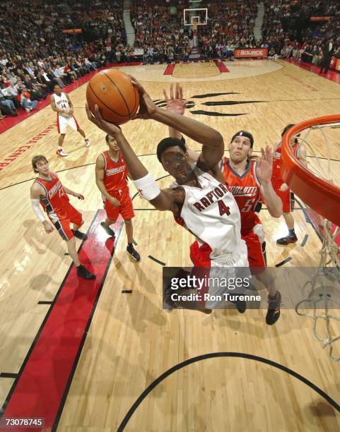 Chris Bosh of the Toronto Raptors drives to the rim past Walter Herrmann of the Charlotte Bobcats January 22, 2007 at the Air Canada Centre in...