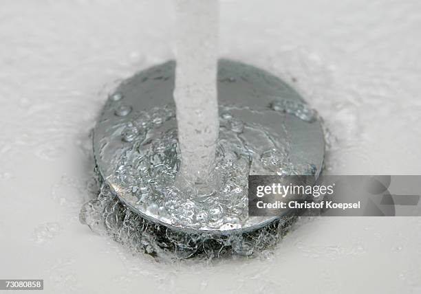 Water pours down the drain of a washbasin on January 10, 2007 in Schwelm, Germany.