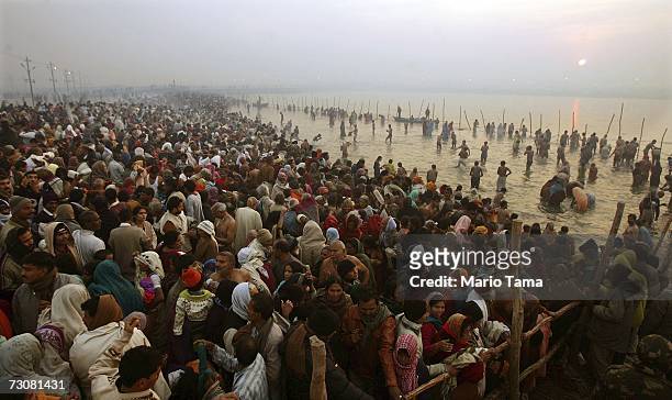 Hindu pilgrims gather to bathe at sunrise at the ritual bathing site at Sangam, the confluence of the Ganges, Yamuna and mythical Saraswati rivers...