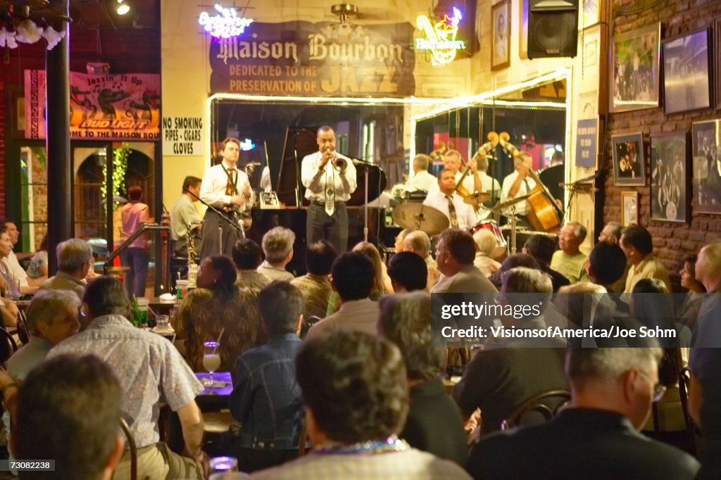 Maison Bourbon Jazz Club with Dixieland band and trumpet player performing at night in French Quarter in New Orleans, Louisiana