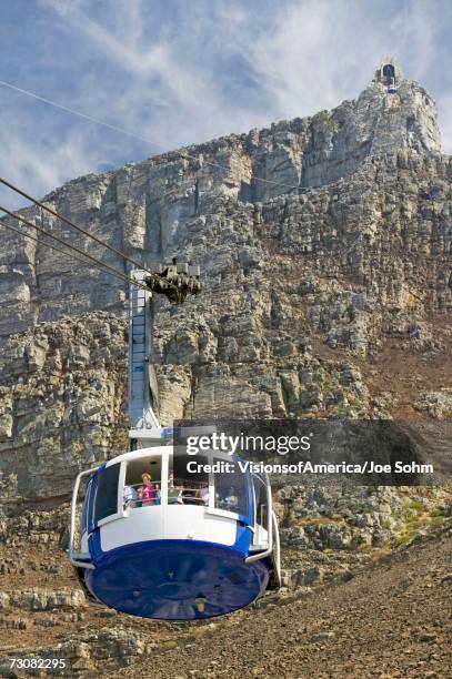 cable car takes tourists to the top of table mountain, cape town, south africa - cape town cable car stock pictures, royalty-free photos & images