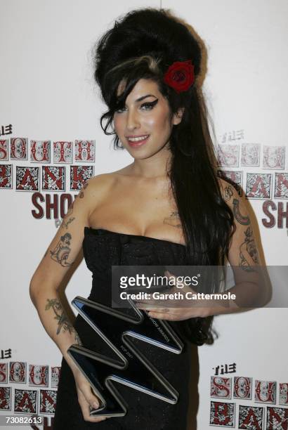 Amy Whinehouse poses with the Pop award for "Back to Black" at the South Bank Show Awards at the Savoy Hotel on January 23, 2007 in London, England.