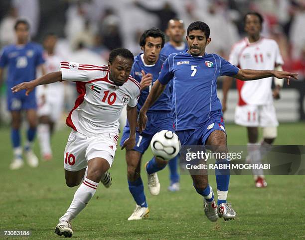 Abu Dhabi, UNITED ARAB EMIRATES: Emirati player Ismail Matar vies with Kuwaiti player Ahmed al-Aidan during their 18th Gulf Cup Championship football...