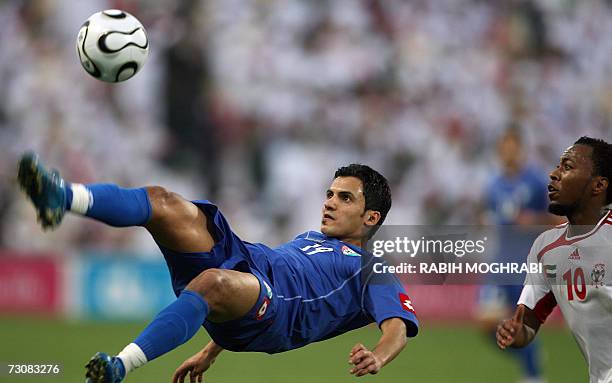 Abu Dhabi, UNITED ARAB EMIRATES: Kuwaiti player Nawaf al-Motairi jumps for the ball as Emirati player Ismail Matar stays alert during their 18th Gulf...