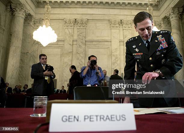 Lt. Gen. David Petraeus checks his watch before the beginning of his nomimation hearing of the Senate Armed Services Committee on Capitol Hill...