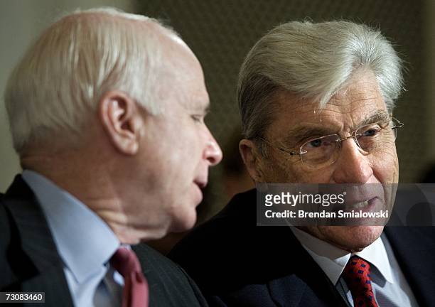Sen. John McCain speaks with U.S. Sen. John Warner during a hearing of the Senate Armed Services Committee on Capitol Hill January 23, 2007 in...
