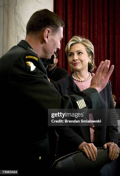 Lt. General David Petraeus speaks with U.S. Sen. Hillary Rodham Clinton before a hearing of the Senate Armed Services Committee on Capitol Hill...