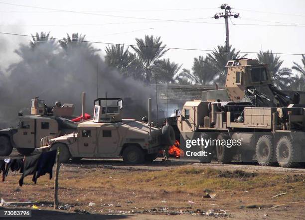 Flames rise from the site where a US military convoy was targeted by a roadside bomb in the restive city of Baquba, northeast of Baghdad, 23 January...