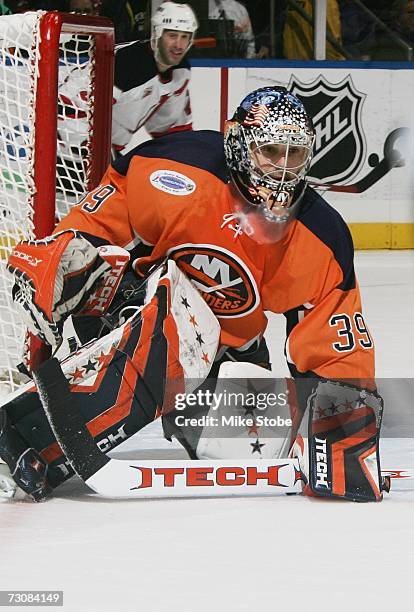 Rick DiPietro of the New York Islanders eyes the puck against the New Jersey Devils on January 13, 2007 at Nassau Coliseum in Uniondale, New York....