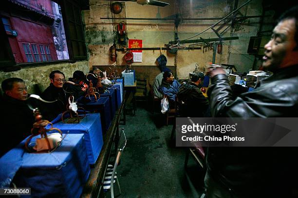 Senior citizens enjoy tea with their bird cages put aside at a Laohuzao teahouse at an alleyway January 23, 2007 in Shanghai, China. Laohuzao is a...