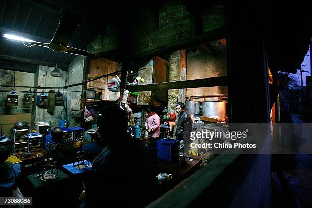 Customers enjoy tea with their bird cages put aside at a Laohuzao teahouse at an alleyway January 23, 2007 in Shanghai, China. Laohuzao is a...