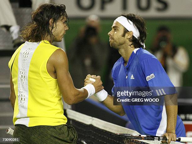 Fernando Gonzalez of Chile shakes hands with Rafael Nadal of Spain following their men's singles quarter-final match at the Australian Open tennis...