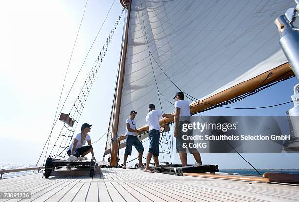 sailboat captain and crew working on deck, ground view - schiffscrew stock-fotos und bilder