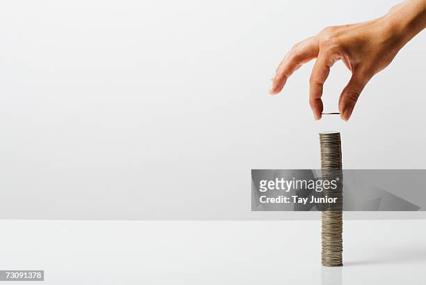 woman stacking coins - coins stockfoto's en -beelden