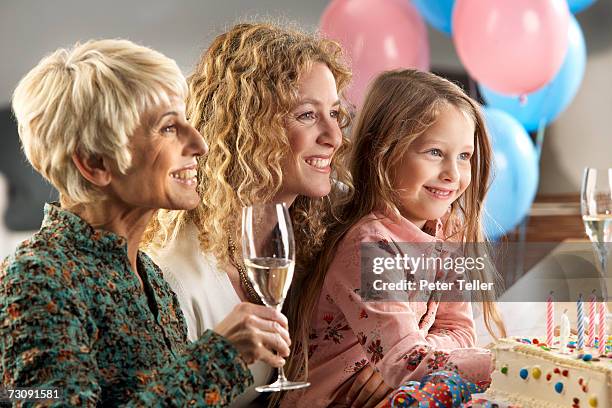 grandmother, mother and daughter (4-5 years) sitting together at birthday party - 4 5 years balloon stock pictures, royalty-free photos & images