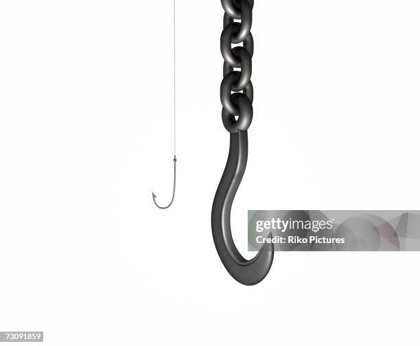 small fishing hook beside large industrial crane hook - fishing hook stockfoto's en -beelden