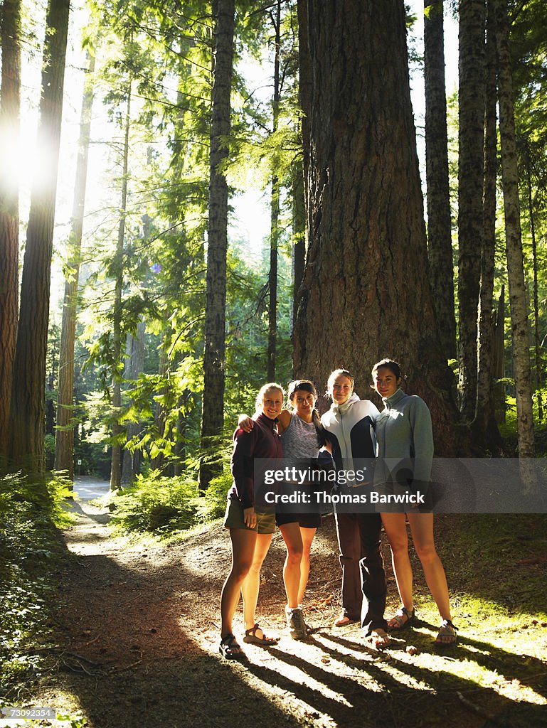 Four women standing in forest, portrait