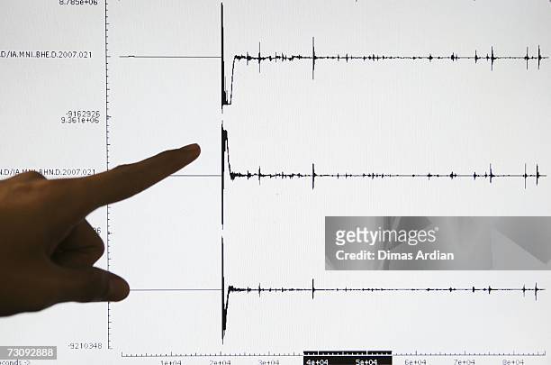 Meteorology and Geophysics Agency officer points to a screen graphic at the BMG office of a 6.5-magnitude earthquake that struck North Sulawesi...