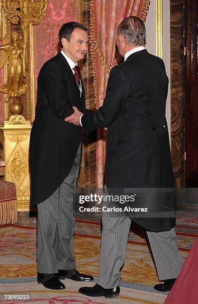 King Juan Carlos of Spain shakes hands with Spanish President Jose Luis Rodriguez Zapatero during a reception for visiting foreign diplomats on...