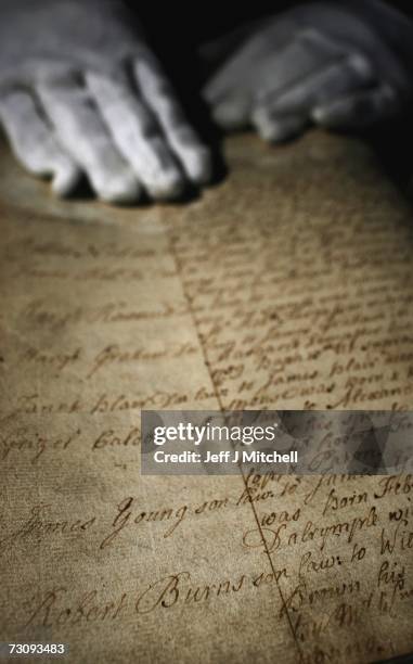 Member of staff at the General Register Office for Scotland holds the birth certificate of Robert Burns on January 24, 2007 in Edinburgh, Scotland....